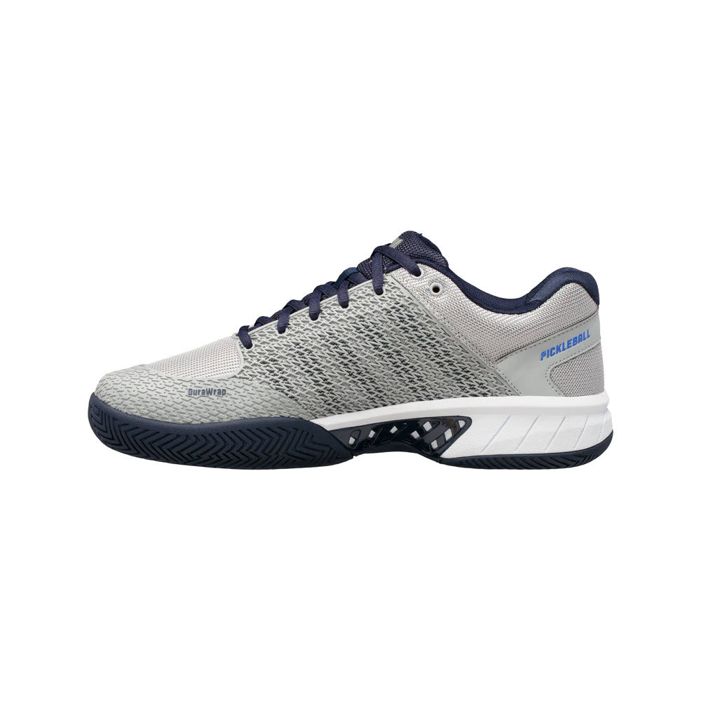 A side view of a K-SWISS EXPRESS LIGHT PICKLEBALL HIGHRISE/NAVY - MENS shoe with &quot;pickleball&quot; text and zigzag sole pattern.