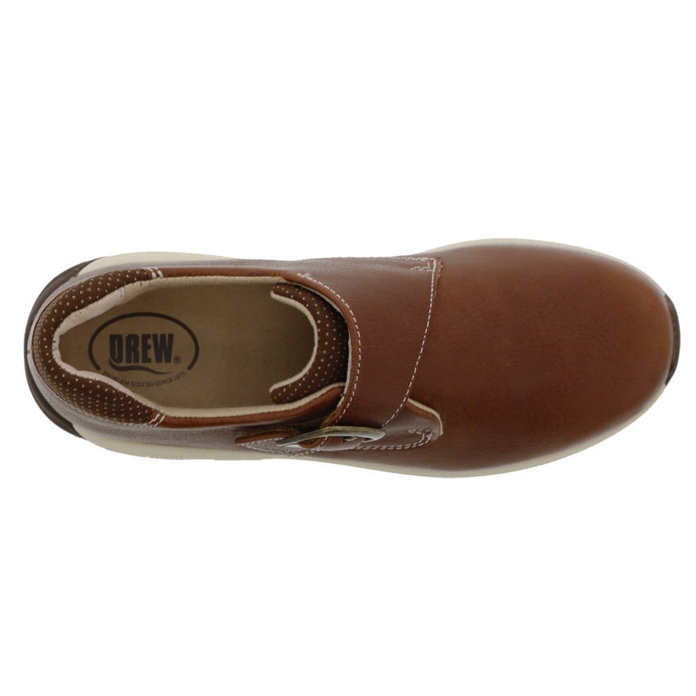 Top view of a brown leather Drew Tempo Camel women&#39;s slip-on shoe with white stitching and a label visible inside.