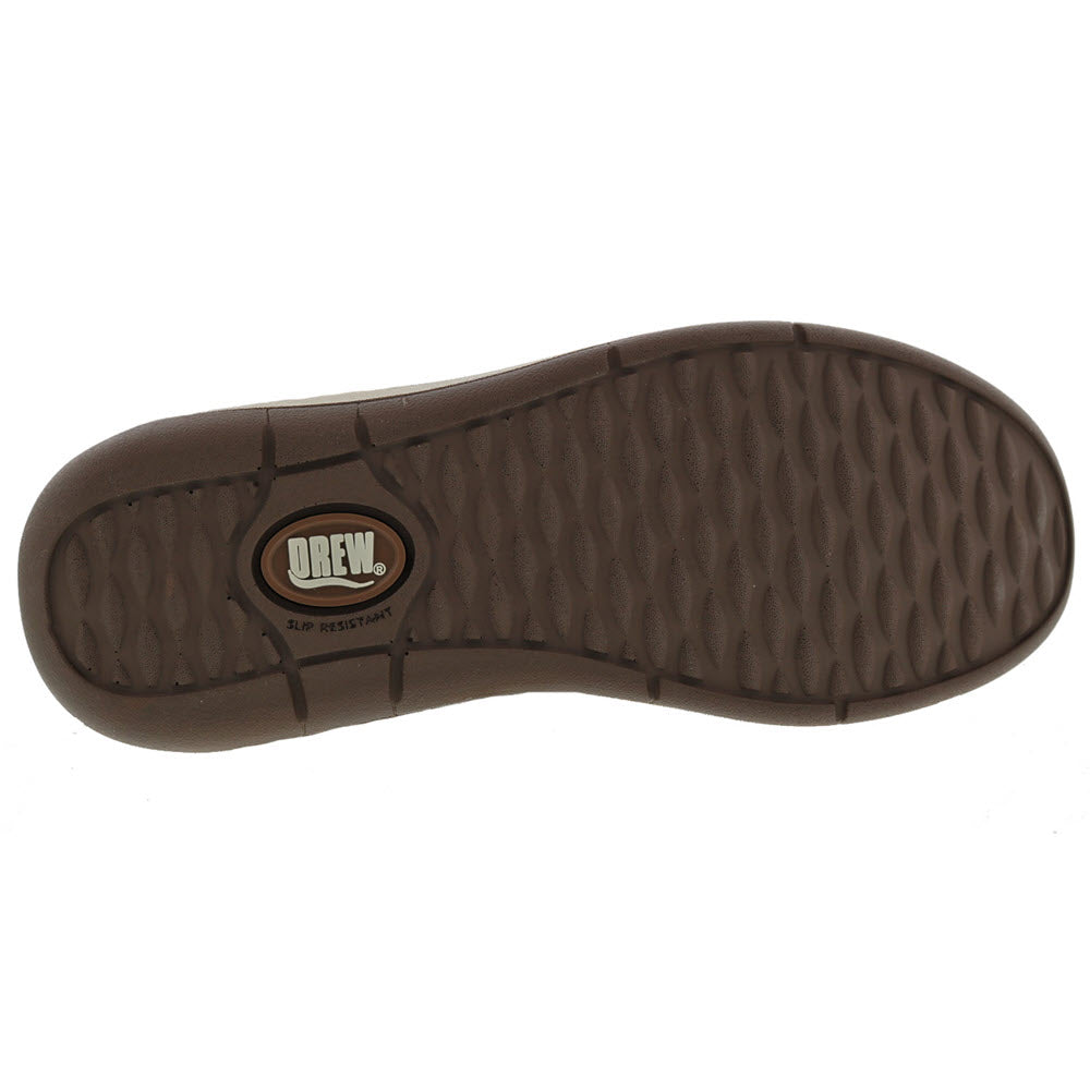 Bottom view of a brown slip-resistant, orthotic-friendly Drew Tempo Camel women&#39;s shoe sole with the brand label &quot;Drew&quot; visible in the center.
