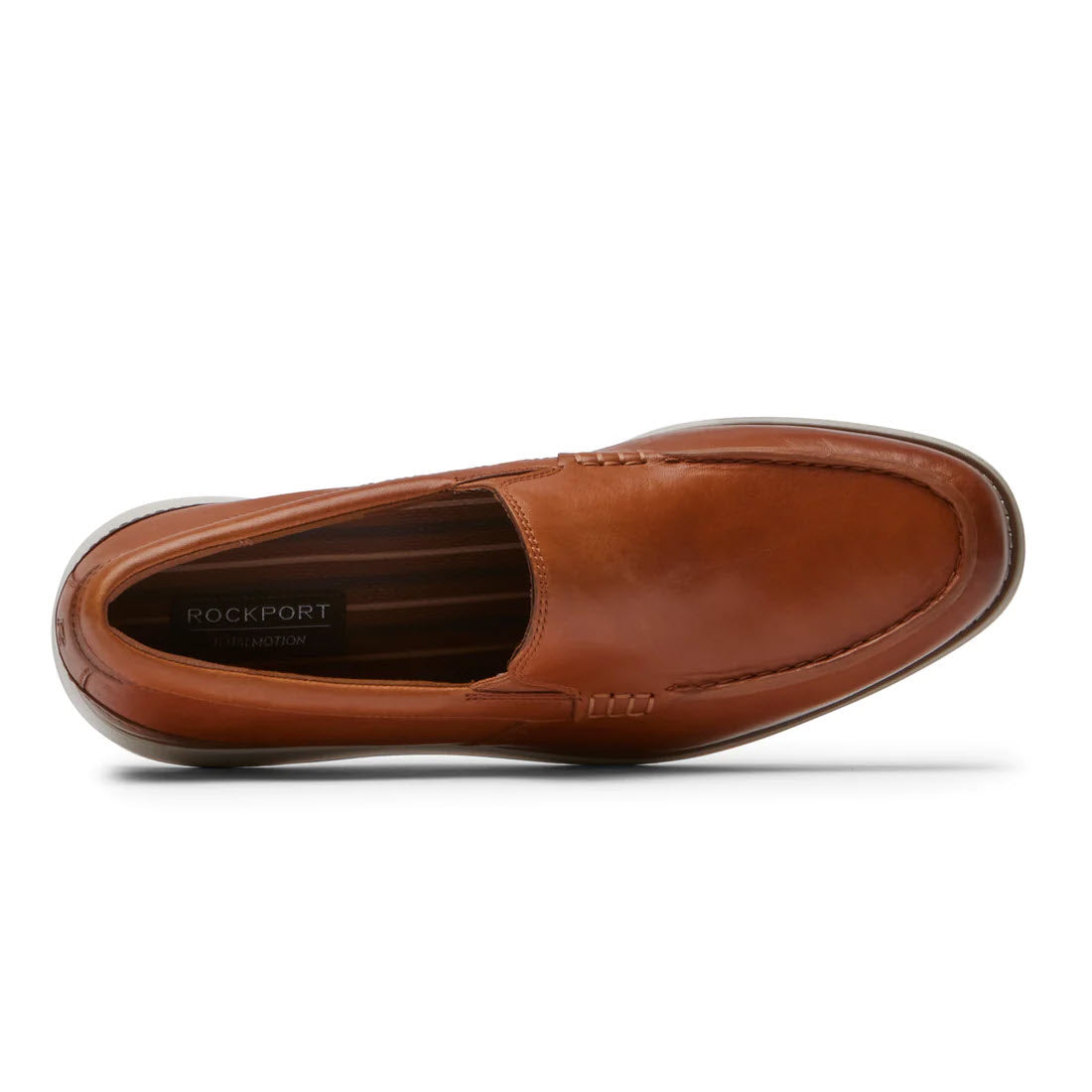 Top view of a single brown Rockport Total Motion Craft Venetian Cognac loafer against a white background.