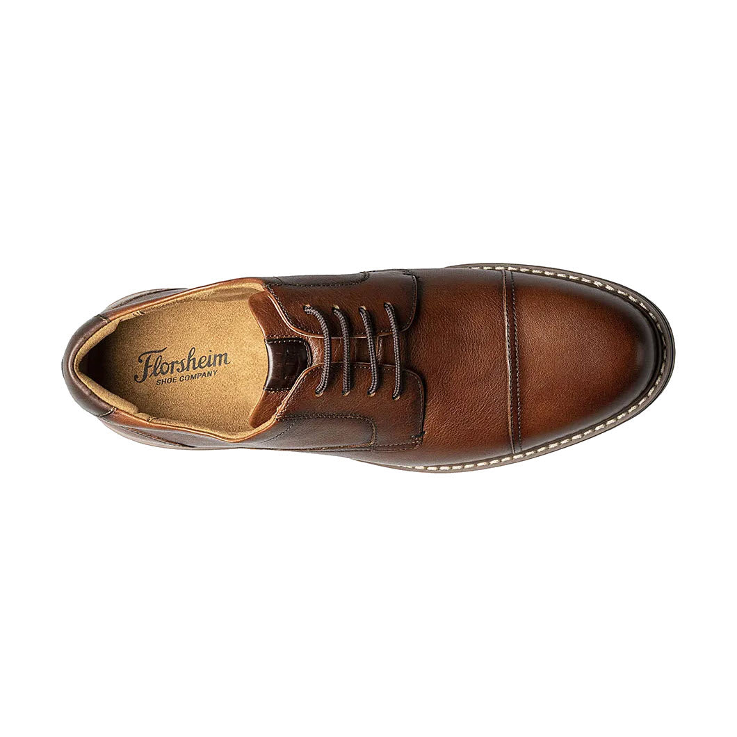 Top view of a Florsheim Norwalk Plain Toe Crazy Horse brown leather dress shoe with laces, showcasing the brand label inside.