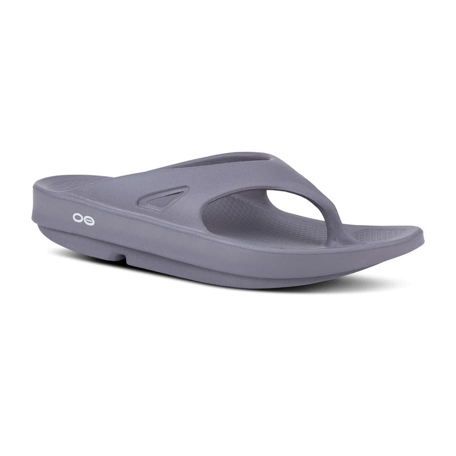 A single gray OOFOS OOriginal Slate flip-flop by Oofos on a white background, featuring a rounded toe hold and a cushioned sole designed to reduce stress on feet.