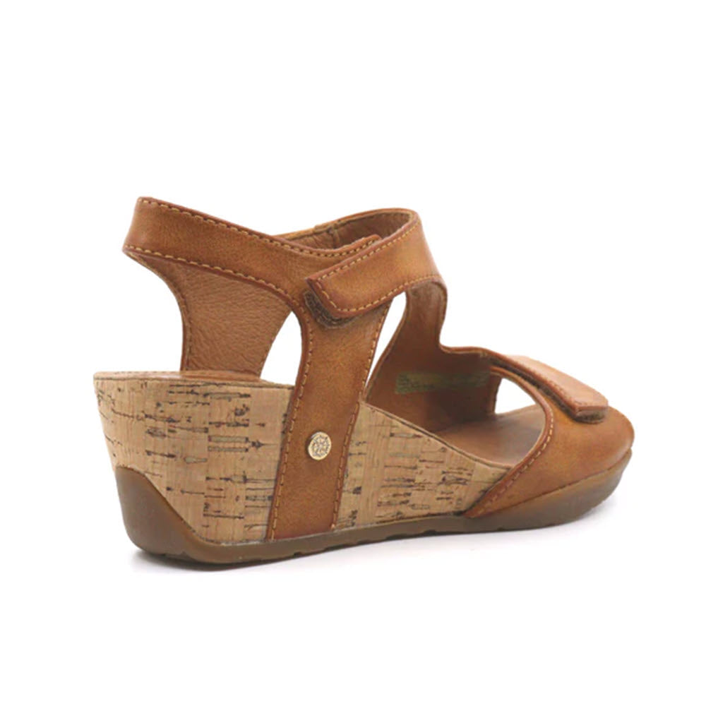 A brown summer shoe with a lightweight cork wedge and a velcro strap closure, isolated on a white background. 
Product Name: BUSSOLA NORMA CUOIO - WOMENS
Brand Name: Bussola