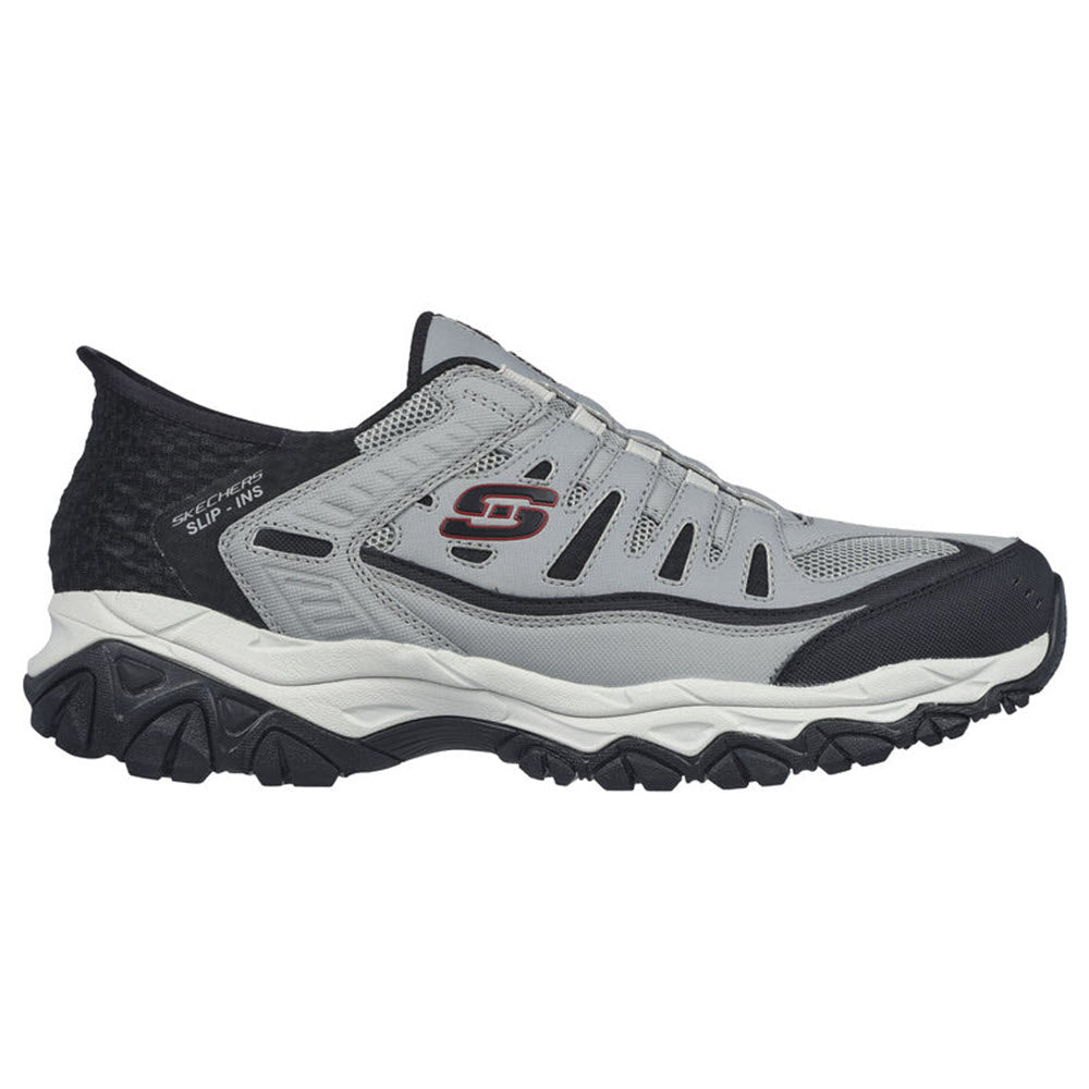 Side view of a gray and black Skechers Arch Fit Slip-ins athletic shoe with visible logo and a thick, sculpted sole.