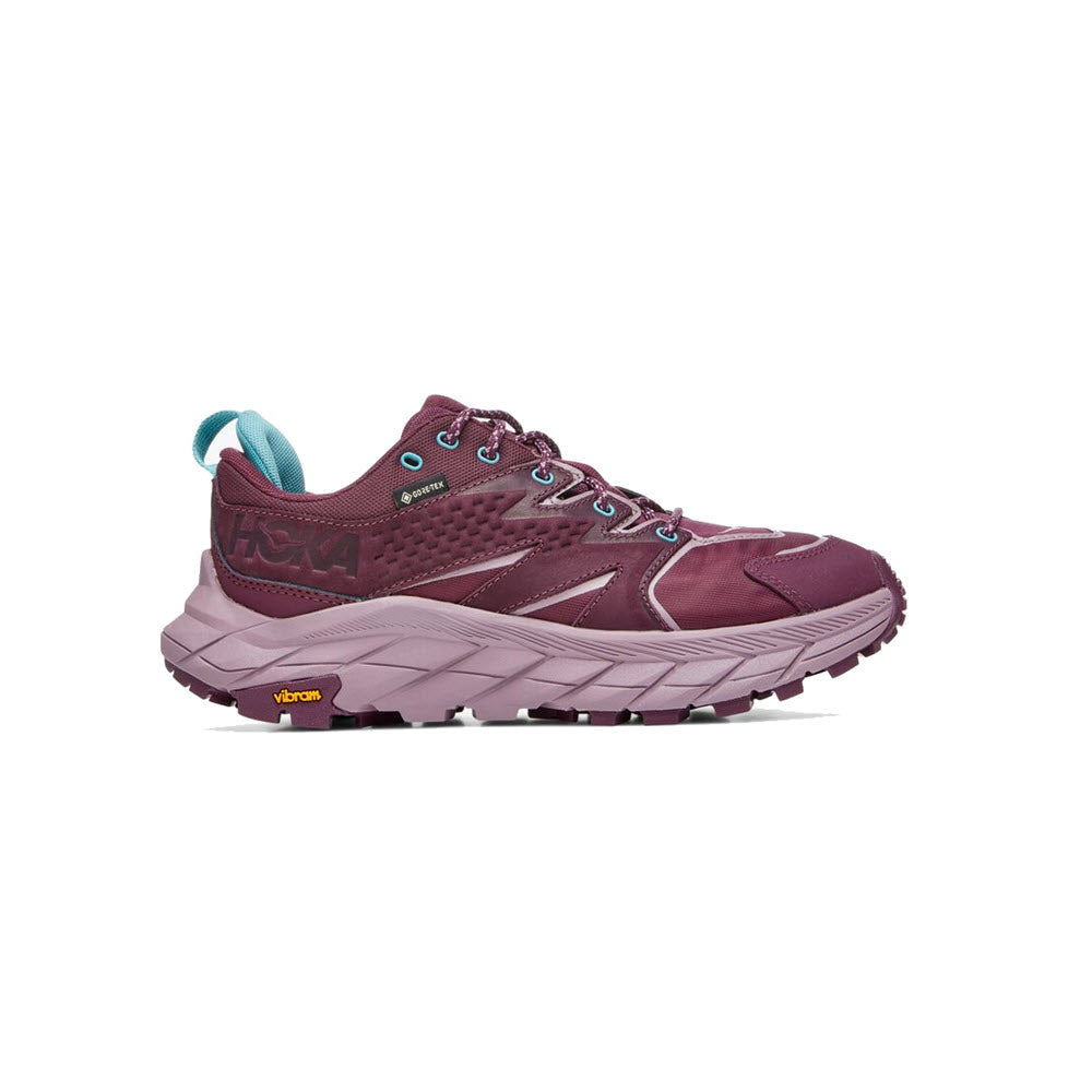 A maroon and teal Hoka Anacapa Low GTX trail running shoe with a vibram sole, shown in side profile against a white background.