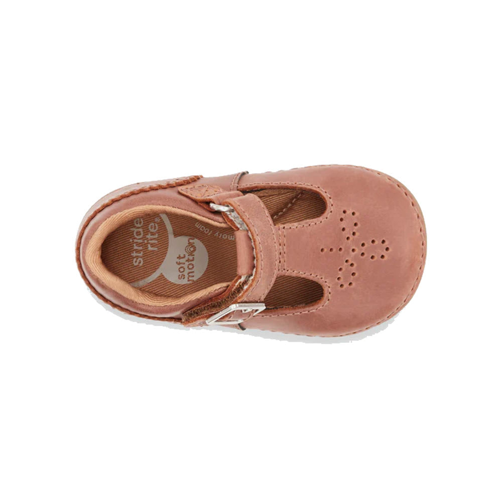 Top view of a single pink Stride Rite SM Lucianne Sierra - Toddlers shoe with a hook and loop closure and decorative perforations on a white background.