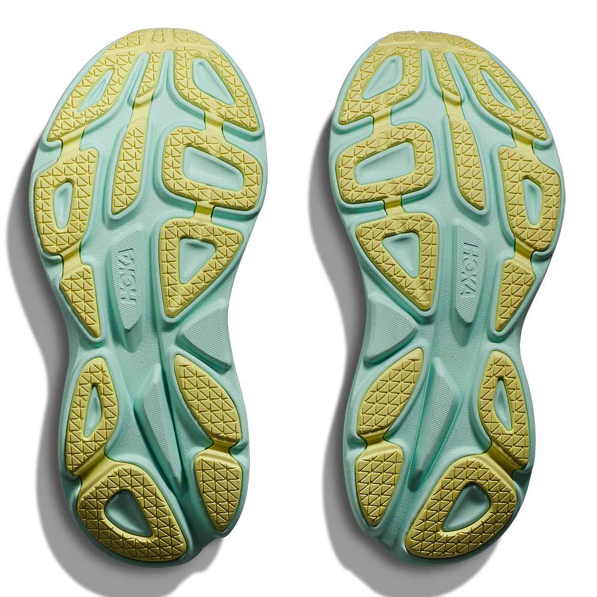Pair of Hoka Bondi 8 Blanc de Blanc/Sunlit Ocean - Womens sport shoe soles with intricate tread patterns and extended heel geometry.