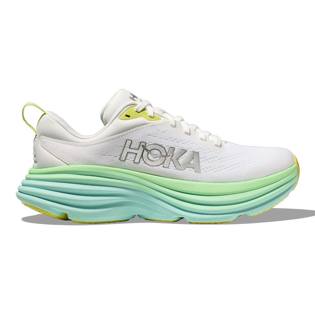 White HOKA BONDI 8 running shoe with thick green sole and yellow accents, featuring the APMA Seal of Acceptance.
