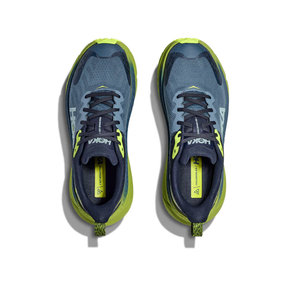 Top view of a pair of Hoka Challenger ATR 7 GTX trail running shoes in blue and yellow colors, isolated on a white background.