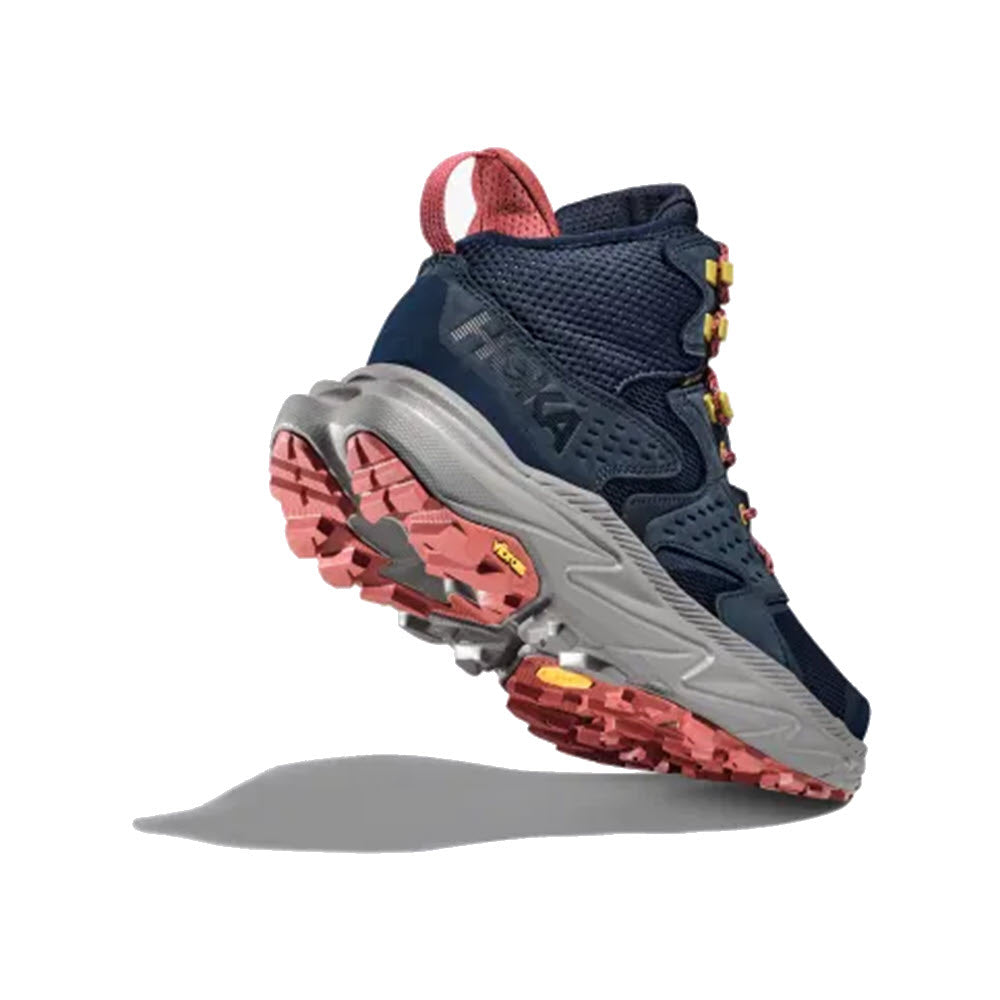 A pair of navy blue and grey Hoka Anacapa 2 Mid GTX hiking boots with red accents and rugged Vibram® Megagrip outsoles, displayed against a white background.