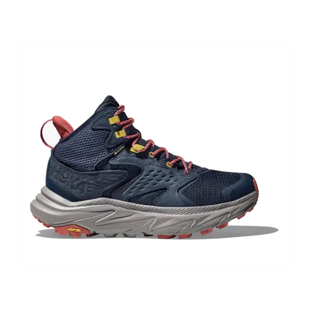 A single navy blue Hoka Anacapa 2 Mid GTX hiking boot with red accents and a chunky, grey Vibram® Megagrip outsole, showcased on a white background.