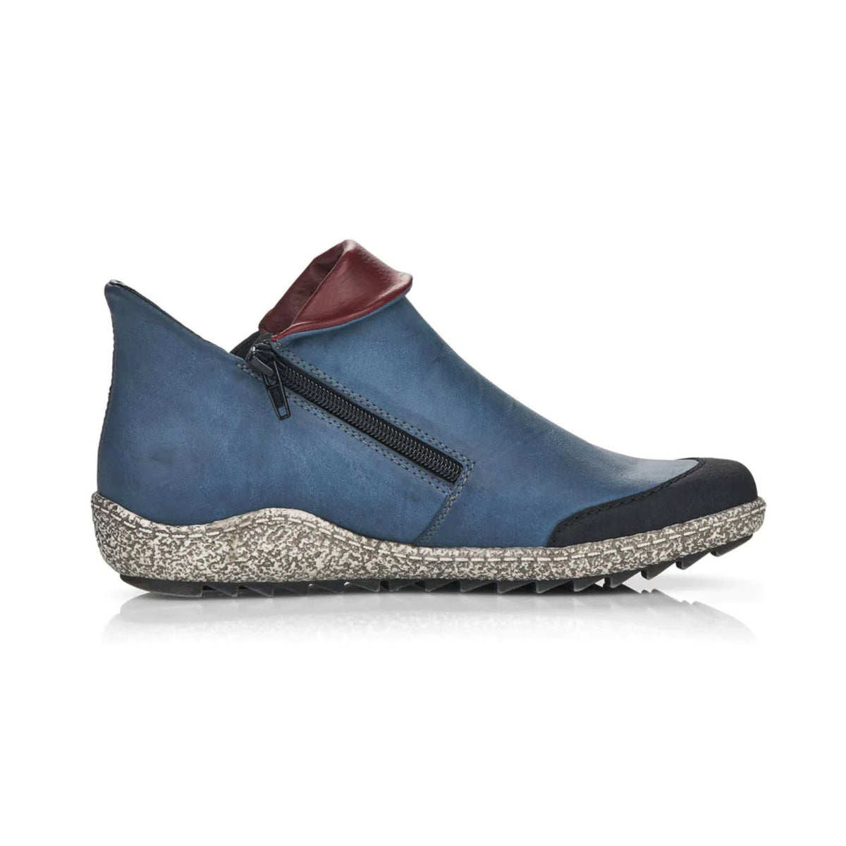 A blue antistress Rieker walking shoe with a side zipper, a contrasting brown Faux Leather patch at the back, and a speckled sole.