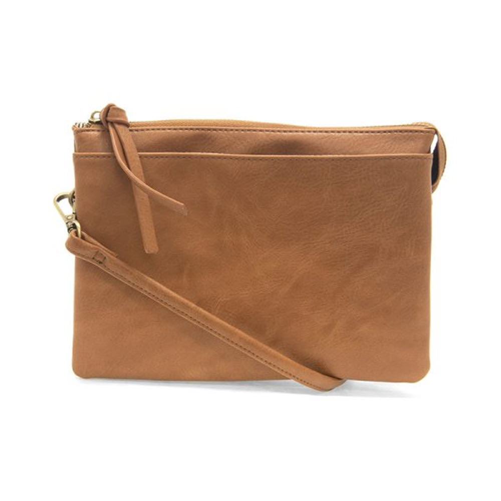 A small, tan leather Joy Piper Multi Pocket Hazelnut crossbody bag with a removable crossbody strap and top zip closure, isolated on a white background.