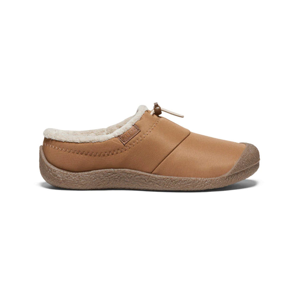 Side view of a Keen KEEN HOWSER III TOASTED COCONUT - WOMENS slip-on shoe with a textured sole, offering hybrid comfort and cozy fit, complete with a plush white lining.