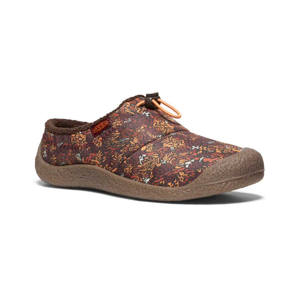 The KEEN HOWSER III SLIDE ANDORRA CAMO - WOMENS by Keen is a multi-color floral pattern slip-on shoe with a toggle closure, featuring a textured sole for enhanced traction and hybrid comfort slide design.