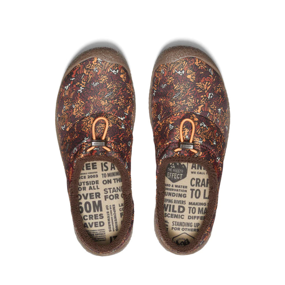 A pair of multi-colored slip-on shoes with a floral pattern and elastic drawcords for that perfect fit. The insoles boast various text messages in black on a beige background, while the rubber soles ensure excellent traction. Perfect for those seeking a hybrid comfort slide experience, the KEEN HOWSER III SLIDE ANDORRA CAMO - WOMENS by Keen.