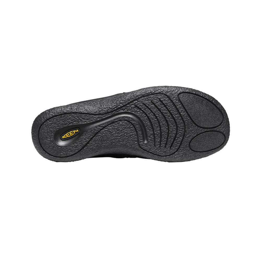 Black rubber sole of a KEEN HOWSER II SLIPPER TRIPLE BLACK - MENS with textured patterns and the Keen logo in the center.