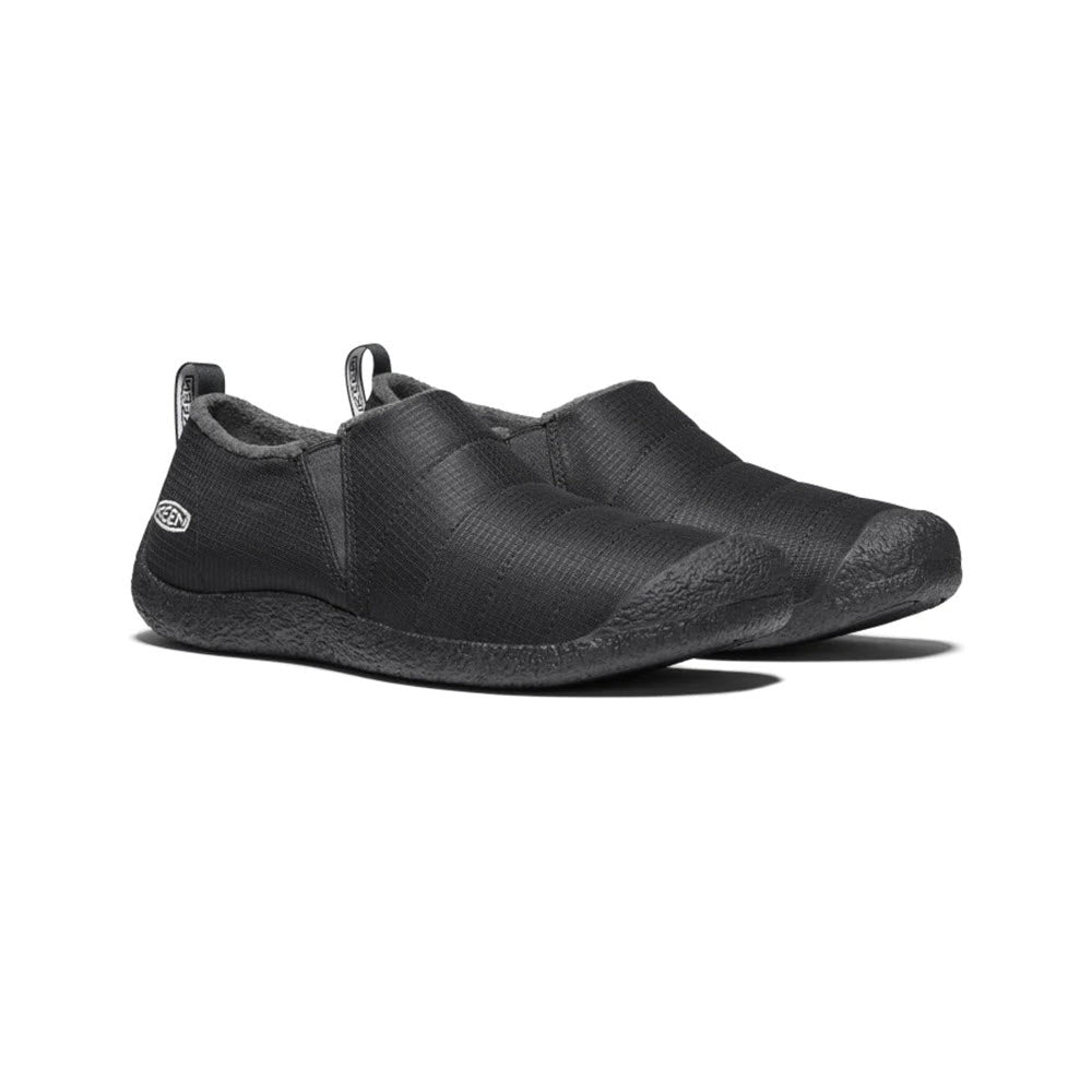 A pair of Keen Howser II slipper triple black - mens with textured uppers and logo on the side, displayed against a white background.