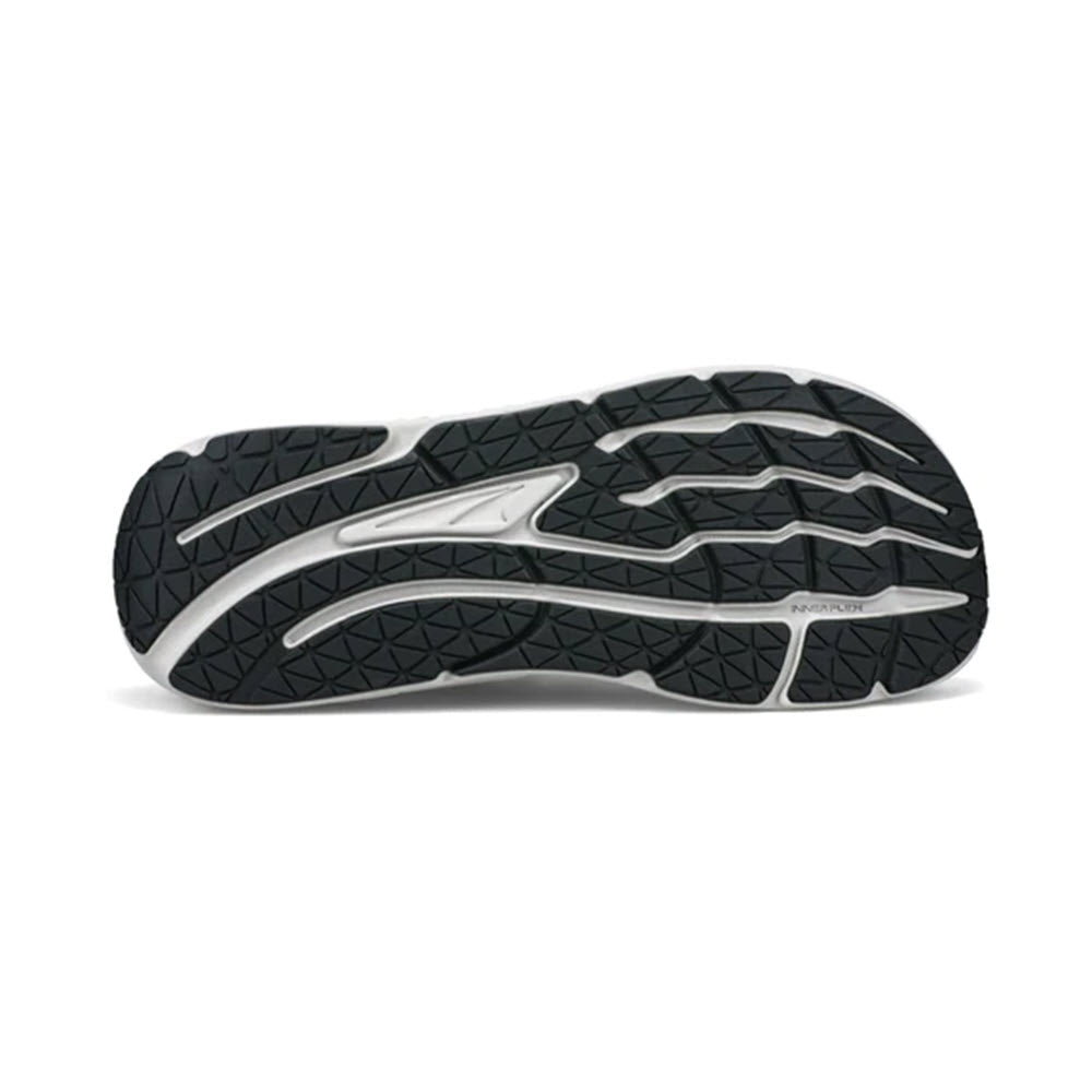 Sole of Altra PARADIGM 7 BLACK - MENS daily trainer sports shoe displaying a black rubber tread with a complex pattern and a prominent white logo on its side.