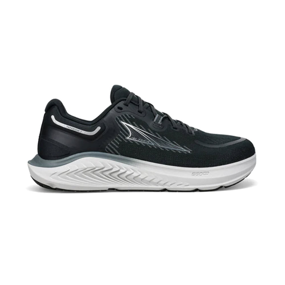 A black and white daily trainer featuring a prominent curved sole and a sleek, streamlined design with visible Altra logo on the side.