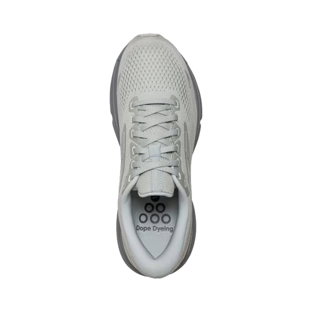 Top view of a Brooks Ghost 15 Green Silence - Womens running shoe with white laces and a unique sole design, featuring circular black patterns under the forefoot.