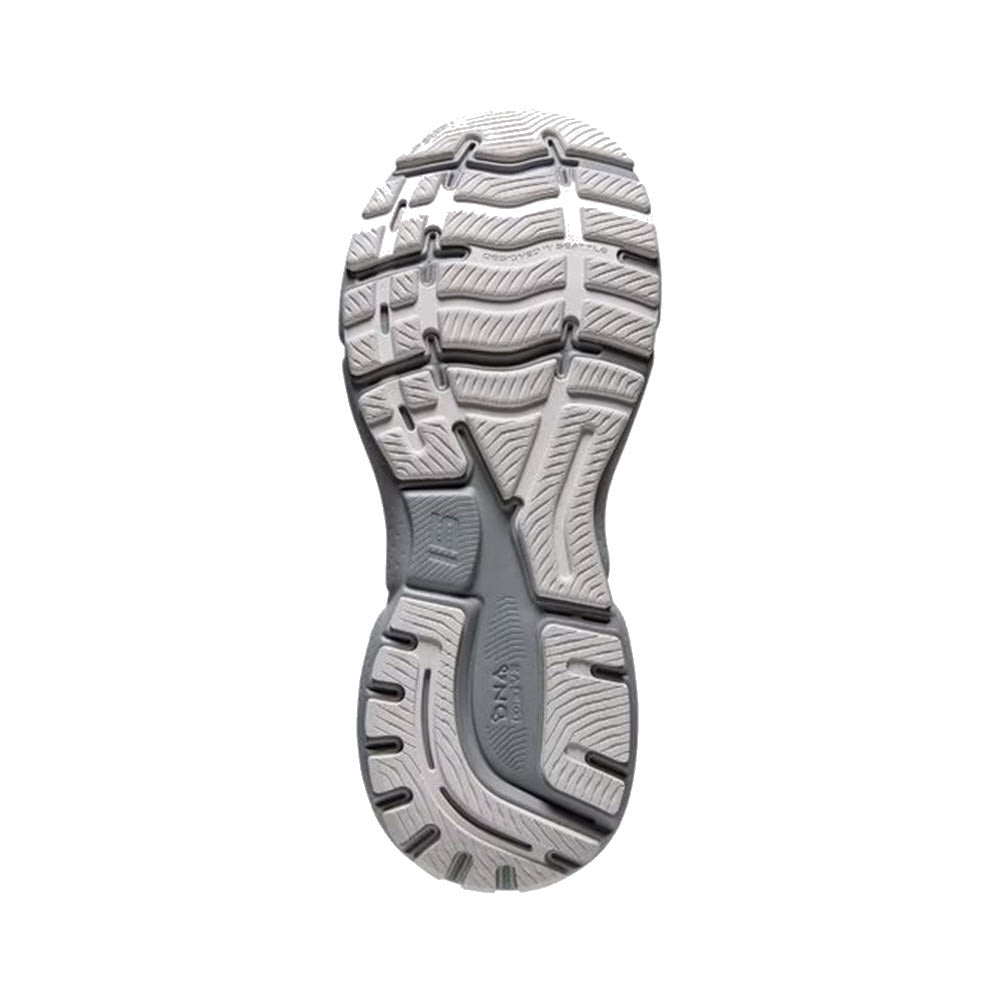 Bottom view of a textured rubber sole of a Brooks Ghost 15 Green Silence - Women&#39;s running shoe, featuring intricate tread patterns for grip.