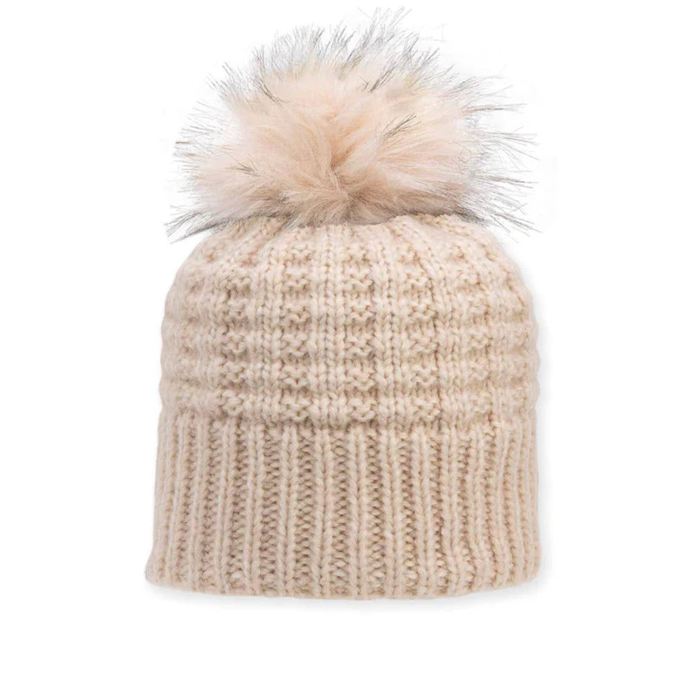 A beige knit winter hat with a ribbed pattern and a large, fluffy pom-pom on top, set against a white background.