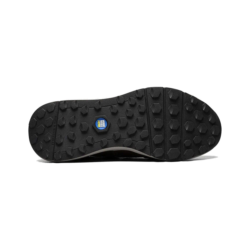 Sole of a black hiking shoe featuring NUNN BUSH EXCURSION MOC TOE OXFORD CRAZY HORSE BROWN - MENS technology, with a rugged tread pattern and a small blue logo in the center.