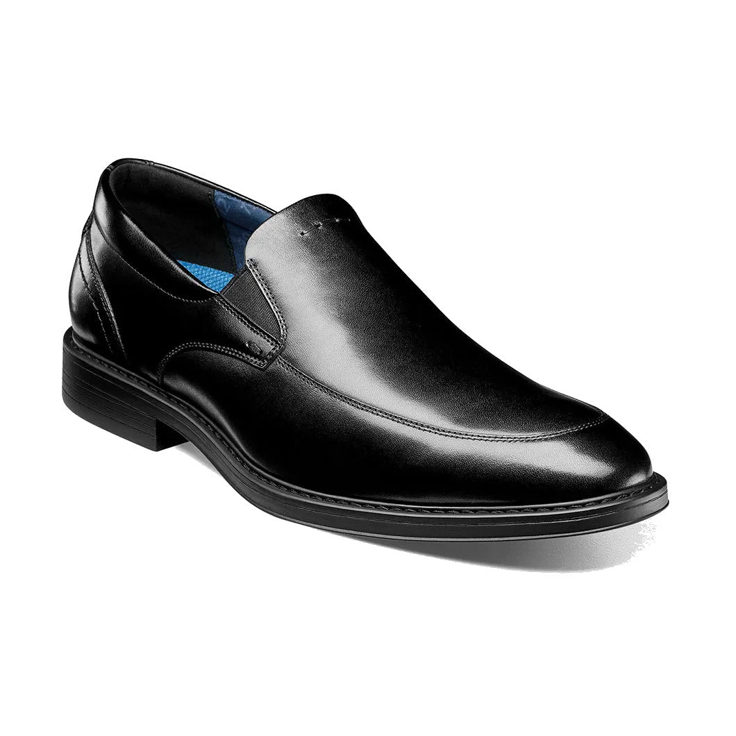 Black leather Nunn Bush Centro Flex Moc Toe Venetian dress shoe with low heel and blue interior lining, displayed on a pure white background.