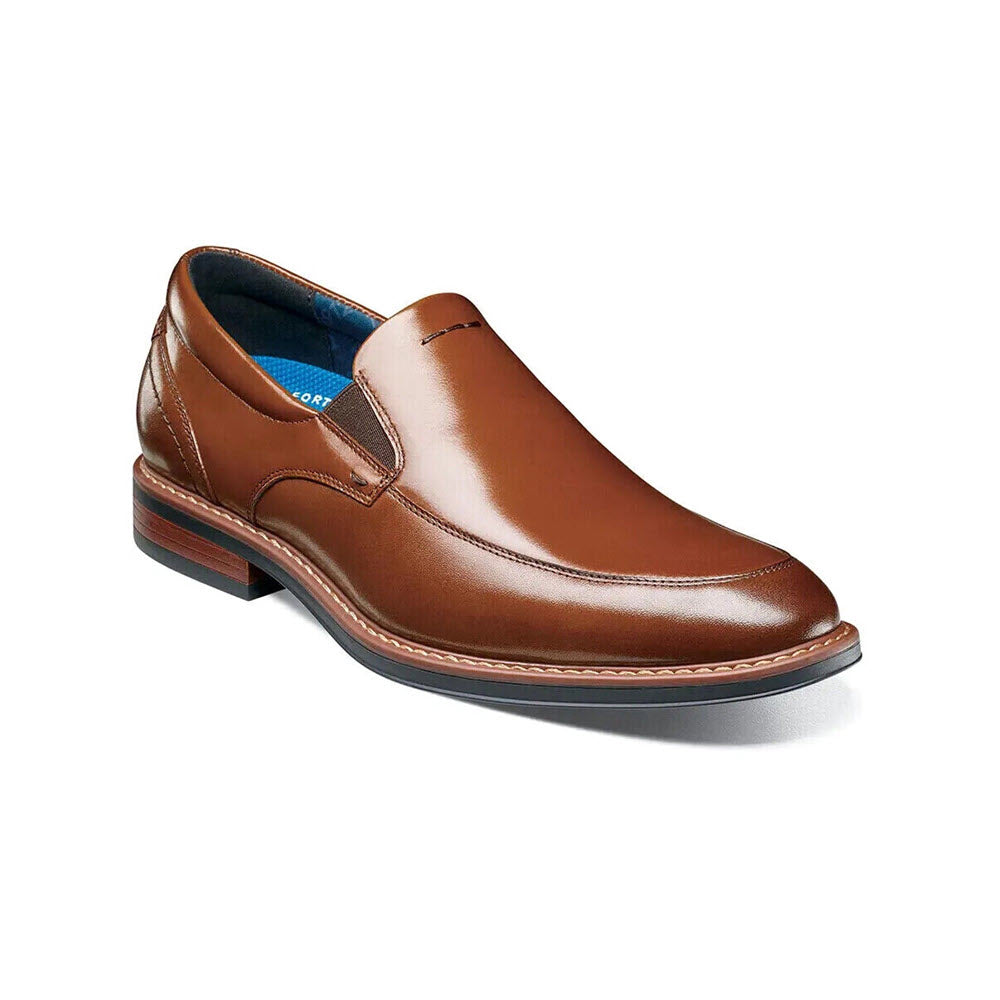 A Nunn Bush Centro Flec Moc Toe Venetian Cognac men&#39;s dress shoe, featuring a Moc Toe Venetian Slip-On design, with blue interior lining and a small heel, displayed against a white background.