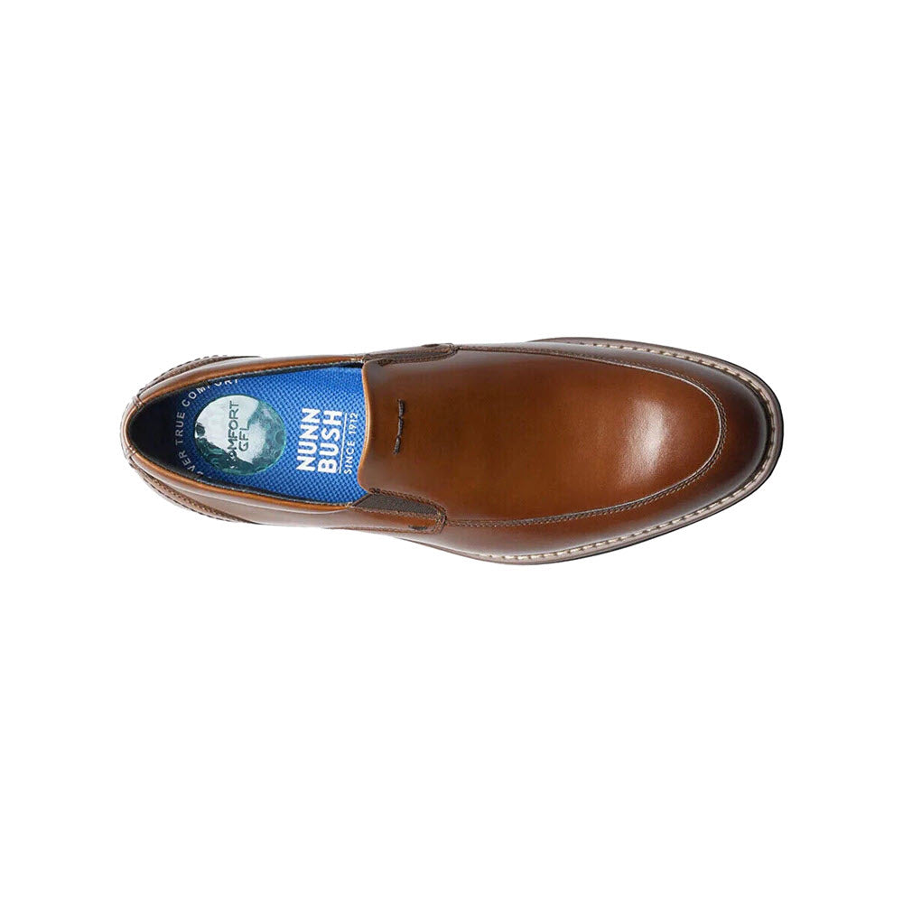 A top view of a single brown leather Nunn Bush Centro Flec Moc Toe Venetian Slip-On with a blue inner lining and logo visible on the insole.