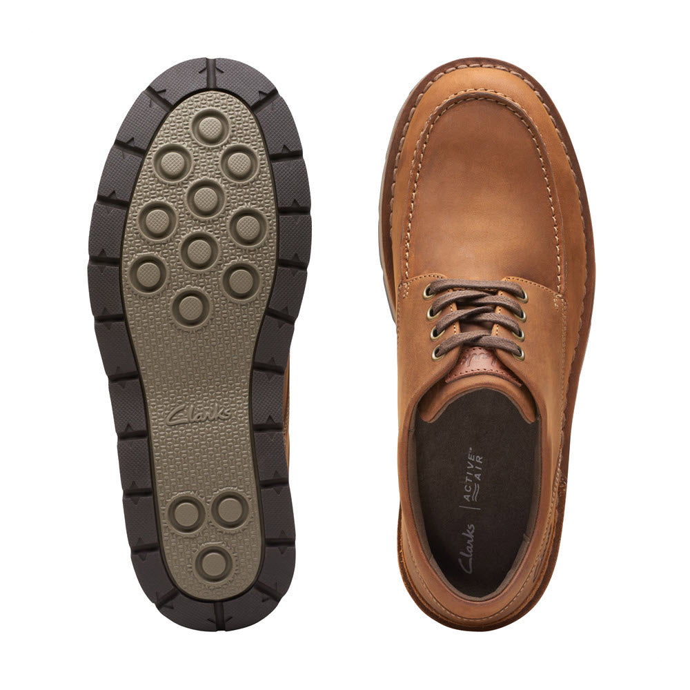 A pair of Clarks Gravelle Low Lace Oxford Dark Brown Nubuck shoes, one flipped to show the Active Air technology sole and the other right side up to display the tan nubuck upper.