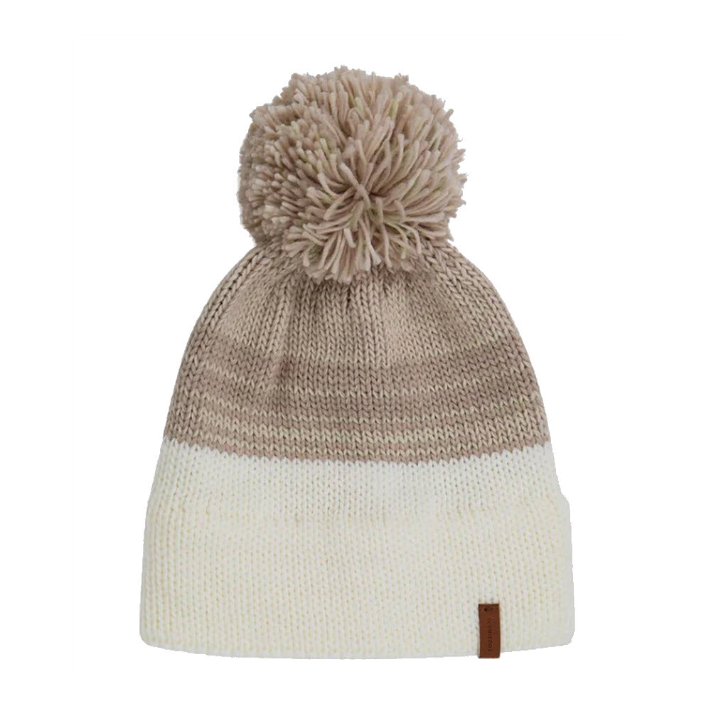 A KOORINGAL MANSFIELD BEANIE SNOW WHITE with a pom pom on top, featuring cream and tan stripes, and a small brown logo tag on the brim.