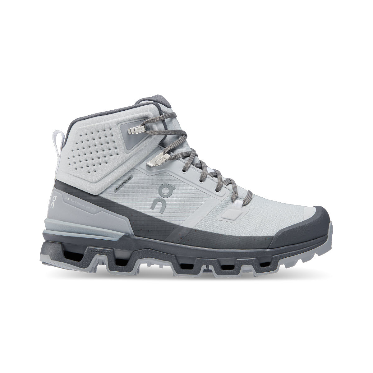 A light gray and dark gray hiking boot with a mid-ankle design, sturdy sole, and lace-up front. The side features a logo and perforated detailing near the ankle.