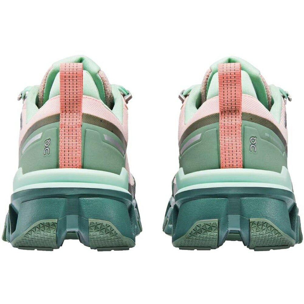 Rear view of a pair of ON CLOUDWANDER WATERPROOF DOE/IVY - WOMENS hiking shoes with rugged soles and reflective heel straps.