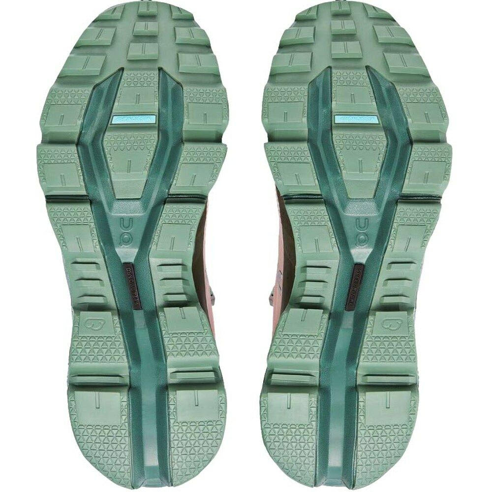 A pair of worn green On Running rubber soles of shoes with visible tread patterns, ideal for outdoor performance.
