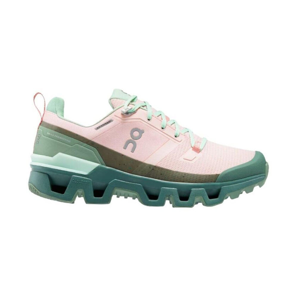 Side view of a pink and mint green ON CLOUDWANDER waterproof running trail sneaker with a rugged sole and logo on the side by On Running.