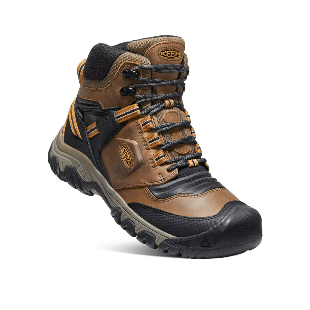 A single Keen Ridge Flex Mid WP Bison/Golden Brown - Mens hiking boot featuring a combination of brown leather and black rubber materials, isolated on a white background.