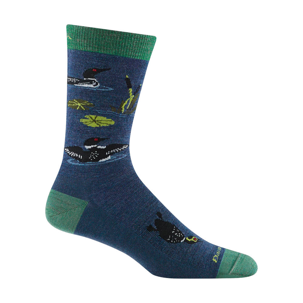A single Darn Tough Merino Wool sock featuring a nature-themed design with black and white birds, green foliage on a dark blue background, and contrasting green toe and heel sections.