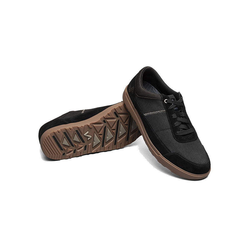 A pair of Forsake Mason Low Waxed Canvas Oxford Black sneakers with a breathable suede patterned brown sole, angled to show the side profile and top view on a white background.