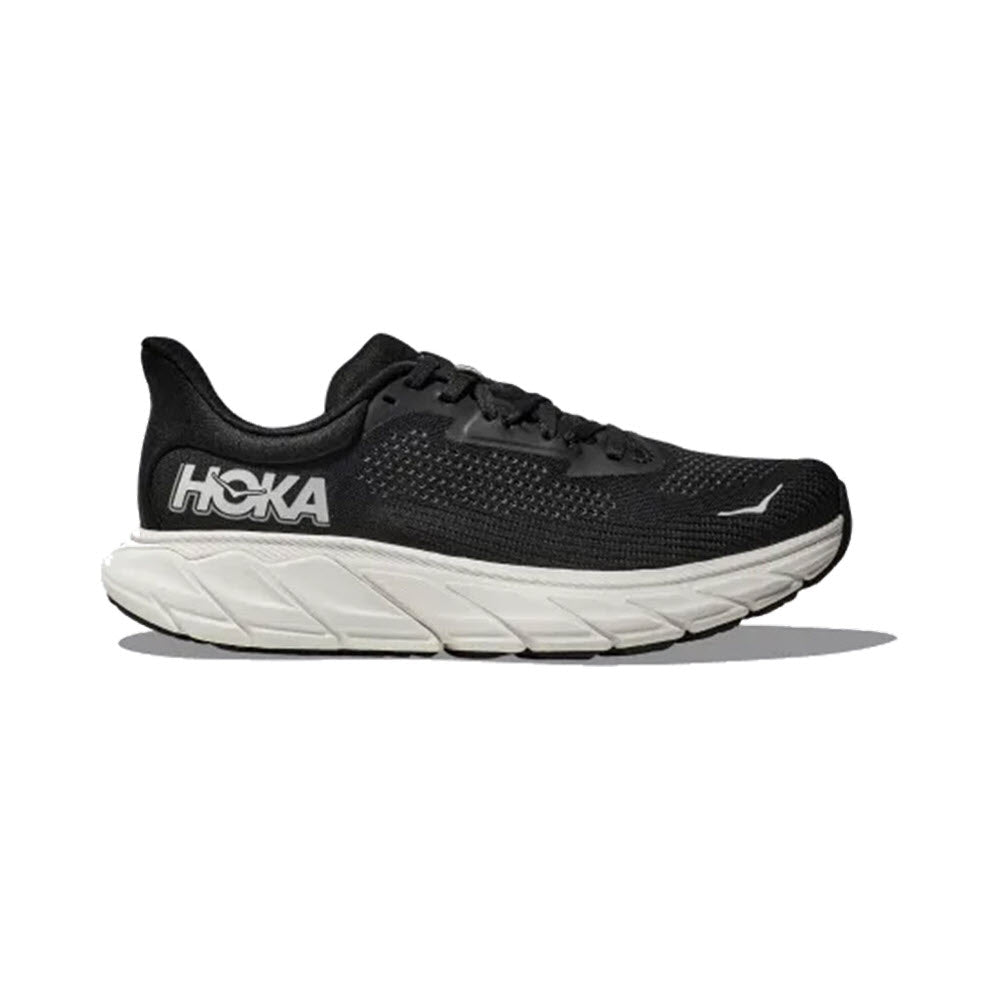 A single black and white HOKA ARAHI 7 running shoe, featuring J-Frame™ technology for enhanced stability, displayed against a neutral background.