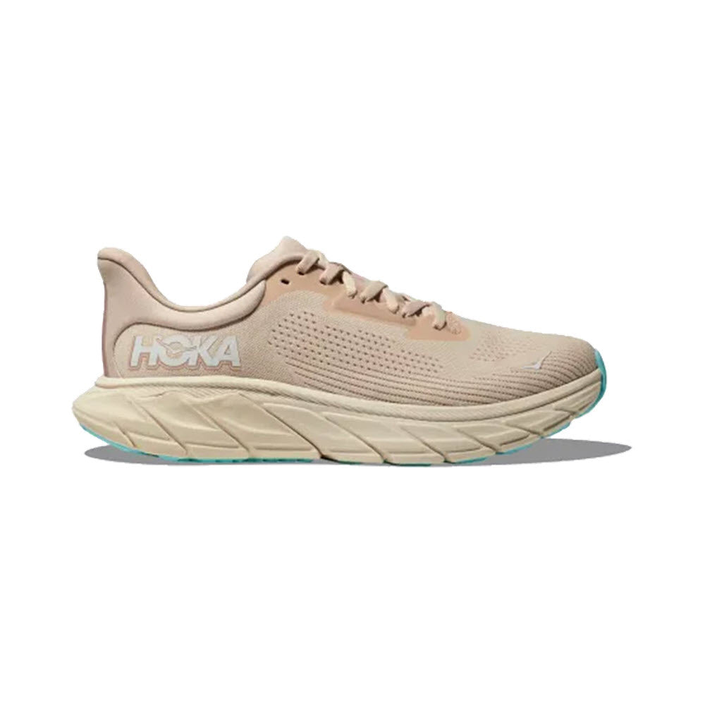 A HOKA ARAHI 7 VANILLA/CREAM - WOMENS stability shoe in beige, featuring a thick, sculpted sole with J-Frame technology and the Hoka logo on the side.