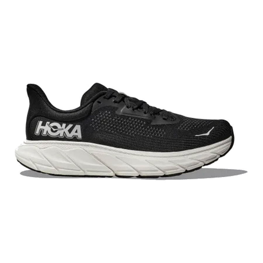 A Hoka Arahi 7 running shoe with a white sole, viewed from the side, displaying the brand logo on its heel.