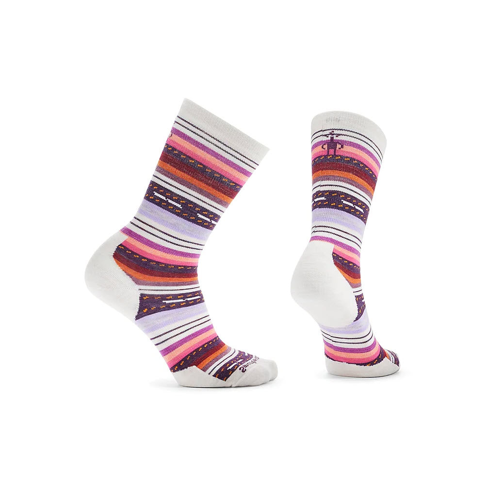 A pair of Smartwool Margarita crew socks in moonbeam, white, purple, red, and blue featuring Shred Shield technology, displayed against a white background, standing upright.