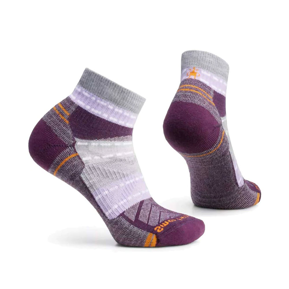 A pair of Smartwool Hike Margarita Ankle socks in ultraviolet standing upright against a white background.