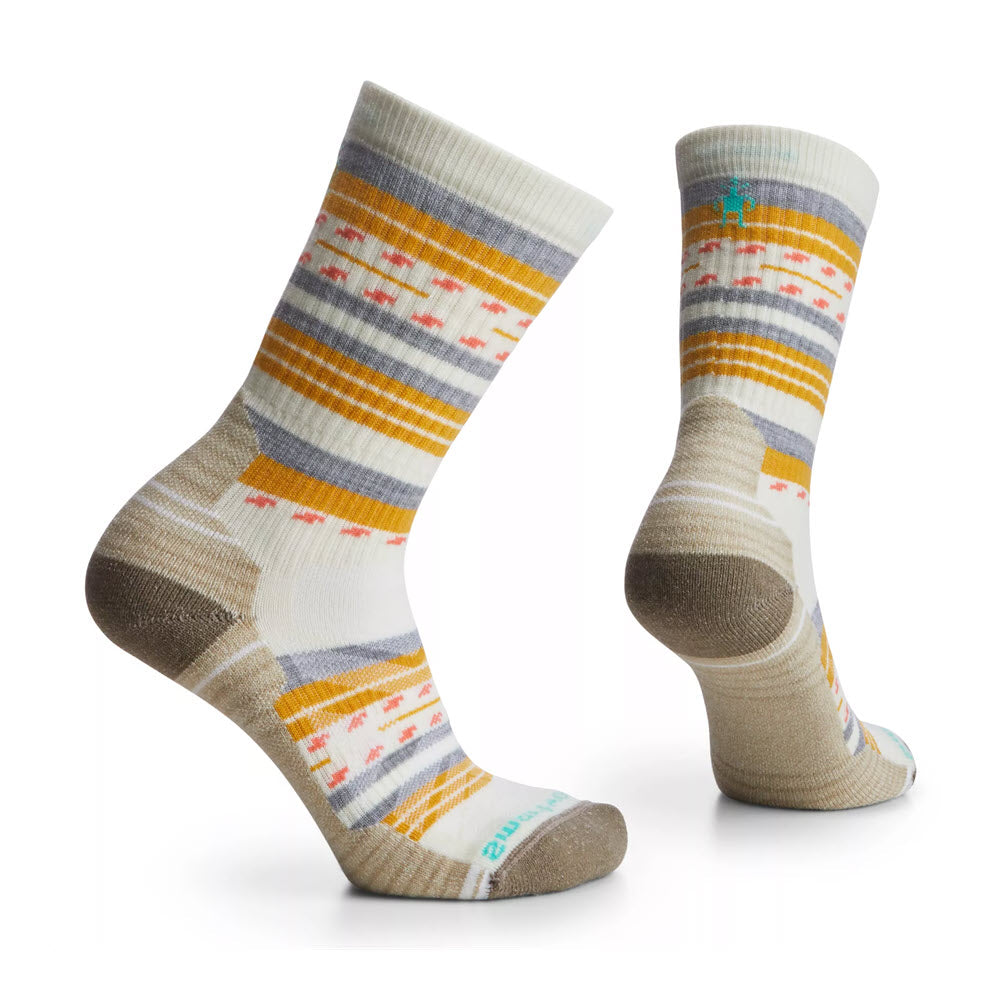 A pair of Smartwool women&#39;s wool hiking socks in white, yellow, blue, and red stripes, standing upright, isolated on a white background.