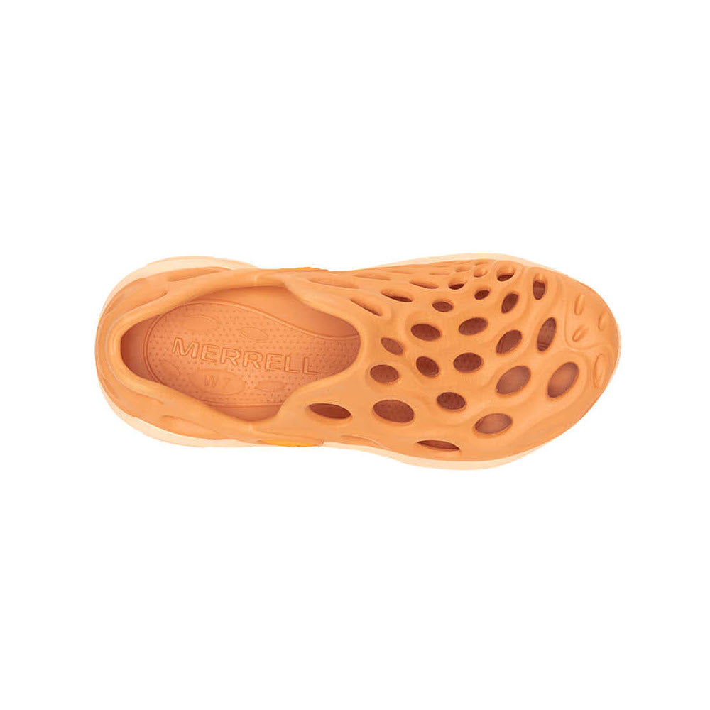 Orange Merrell Hydro Next Gen Moc Melon slip-on shoe with a pattern of circular cutouts on the sole and upper, isolated against a white background.