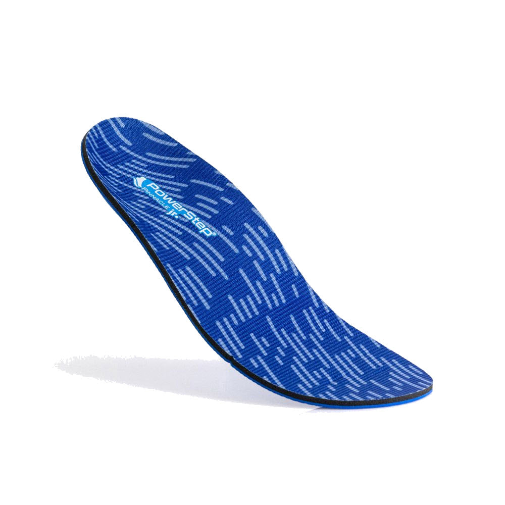A blue skateboard deck with a geometric pattern and PowerStep Pinnacle Junior logo, displayed at a tilted angle against a white background.