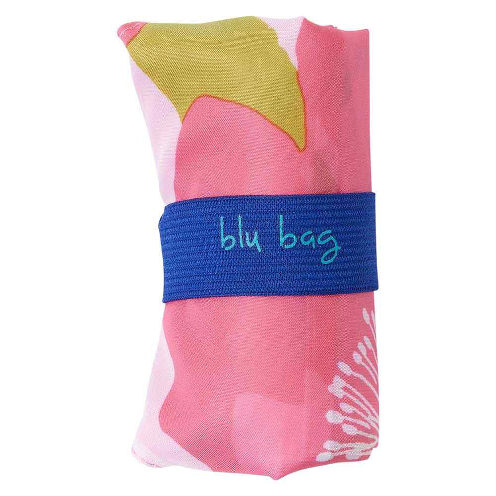 A brightly colored reusable shopping bag folded and secured with a blue strap labeled &quot;BLU BAG POPPIES PINK&quot; by Rockflowerpaper.