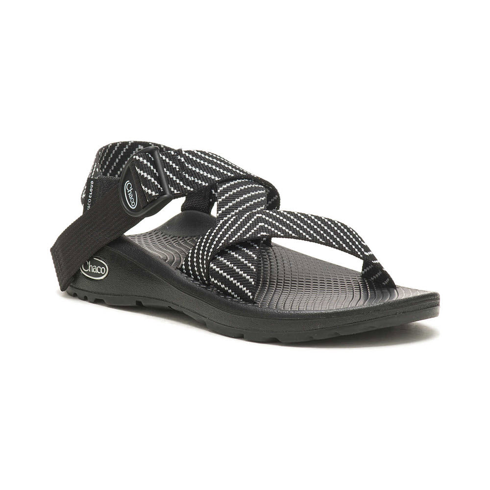 A single CHACO MEGA Z/CLOUD VIBIN B+W - WOMENS sandal featuring crisscross black and white straps with a ChacoGrip rubber outsole, displayed on a white background.